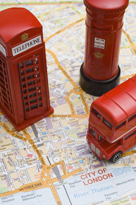 Toy double-decker bus, phone booth, and Royal Mail pillar mailbox on map of London